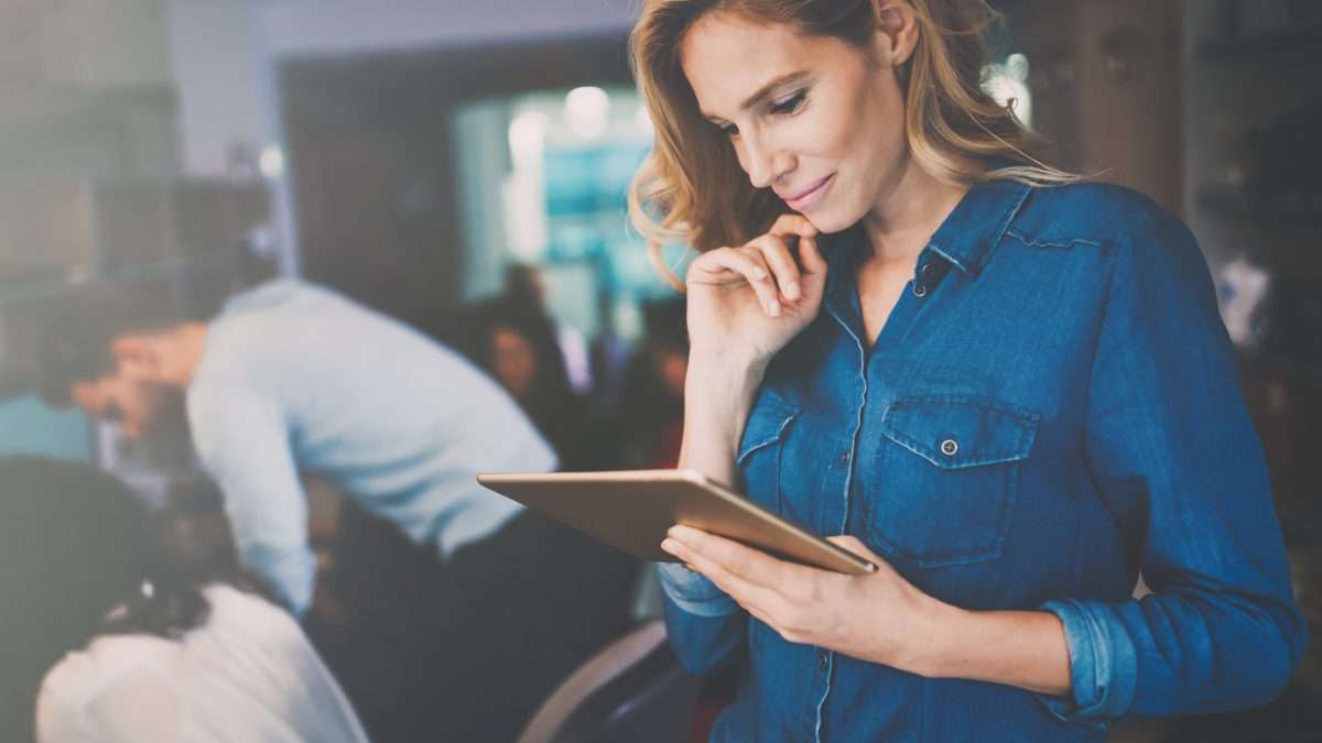 Businesswoman holding tablet in modern office