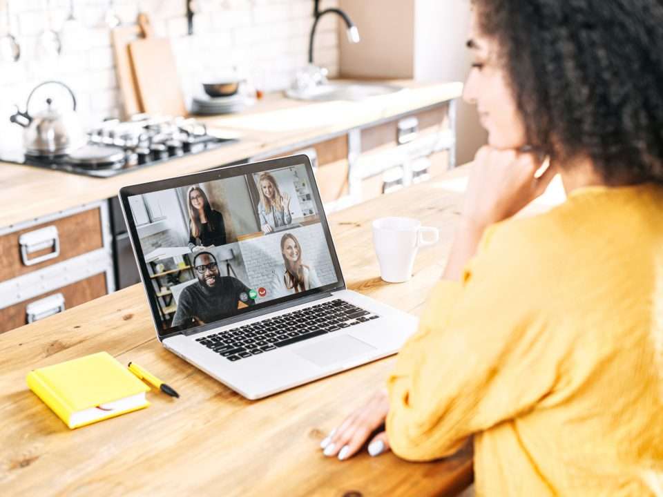 Woman on a laptop video call with four colleagues