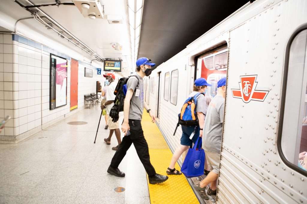 A Good Foot courier steps on to a Toronto subway train.