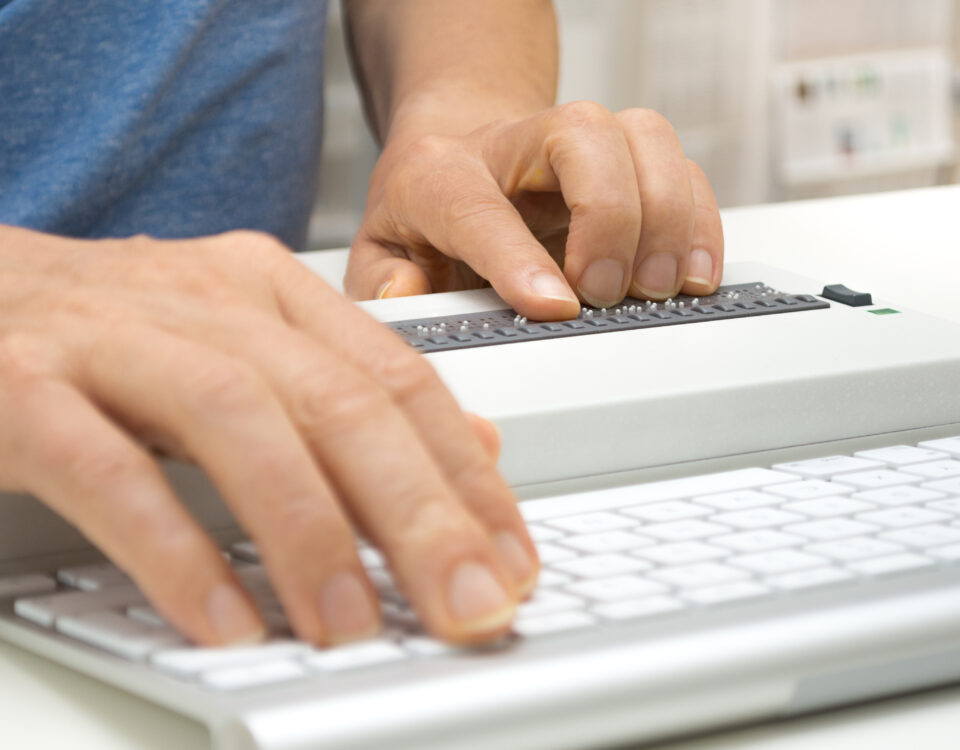 Image of hands typing on braille keyboard